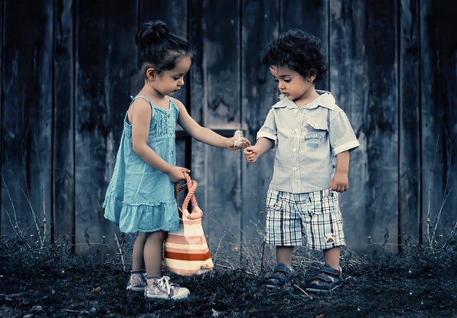A picture of one child giving to another in an article on the Church of Christ Santa Clara website in an article about service and doing unto others