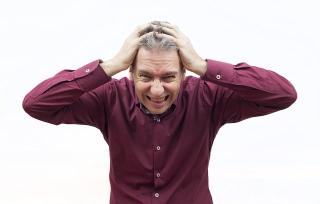 Photo of a man holding his head, appearing stressed in an article at the Church of Christ at Santa Clara SCCOC Truthseekers website.